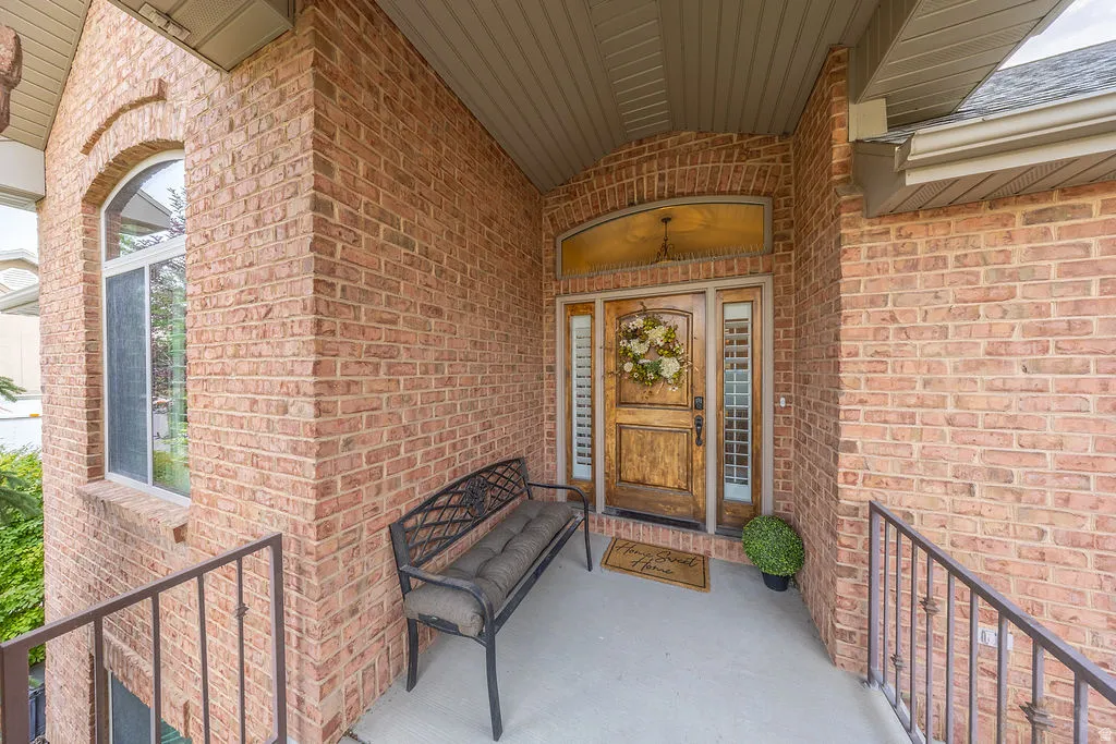 Brick exterior with a prominent arched window and a wood-paneled entry door