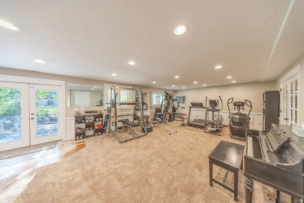 Finished lower-level space featuring wall-to-wall carpeting, recessed lighting, and crisp white trim