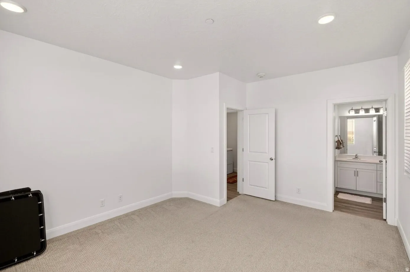 Carpeted room featuring recessed lighting and white baseboards