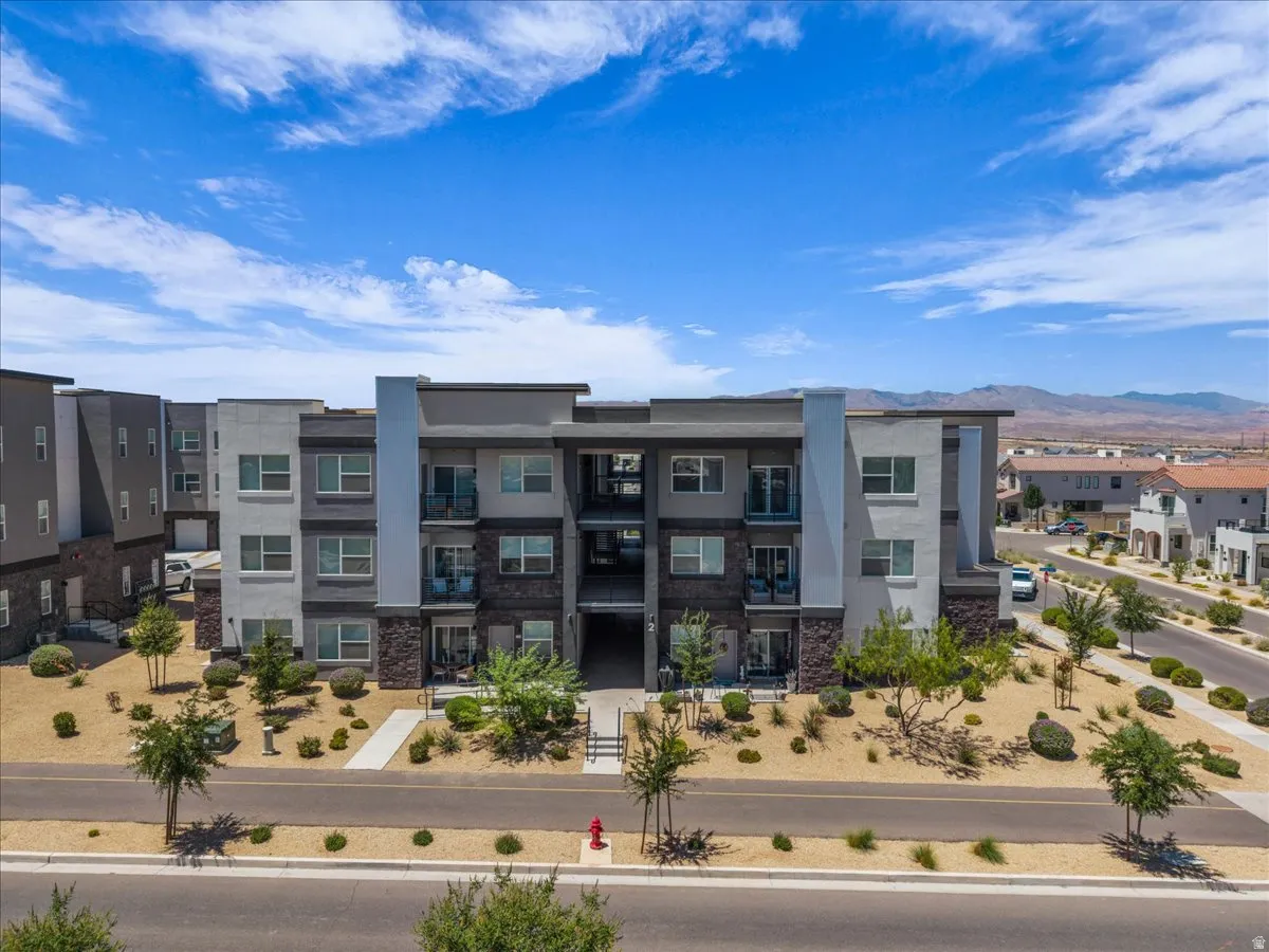 Modern multi-story building featuring stone veneer accents and private balconies