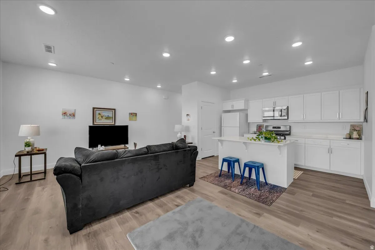 Open-concept living area with wood-finish flooring
