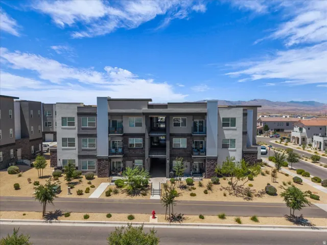 Modern multi-story building featuring stone veneer accents and private balconies