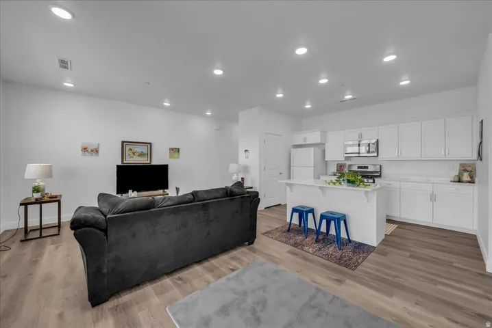 Open-concept living area with wood-finish flooring
