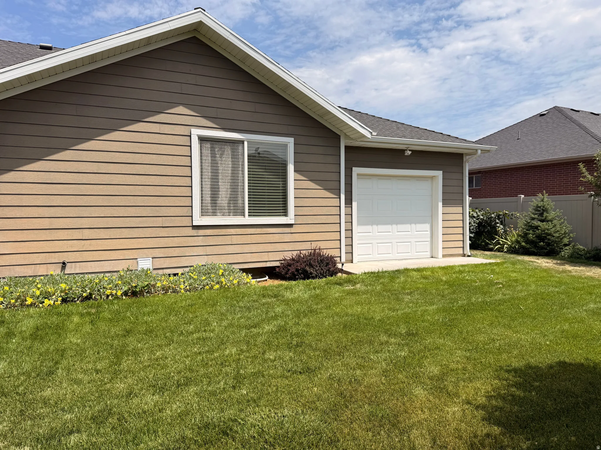 Attached single-car garage with a paneled door