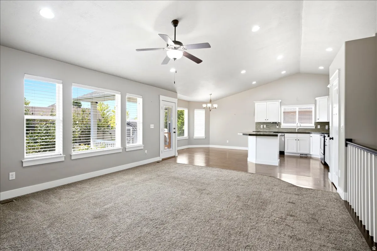Vaulted ceilings and recessed lighting illuminate an open concept living space
