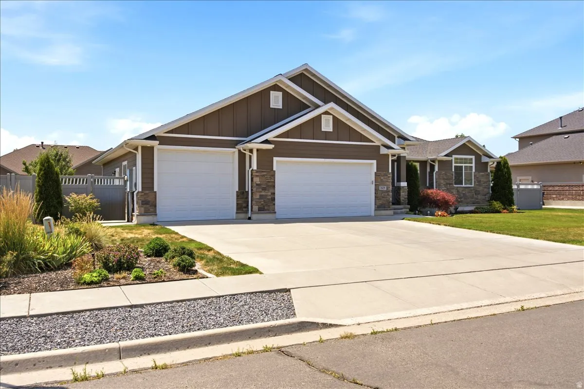 Ranch-style residence featuring a two-car garage and a stone and siding exterior