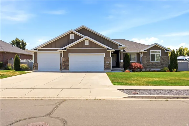 Ranch-style exterior with brown vertical siding and stone accents