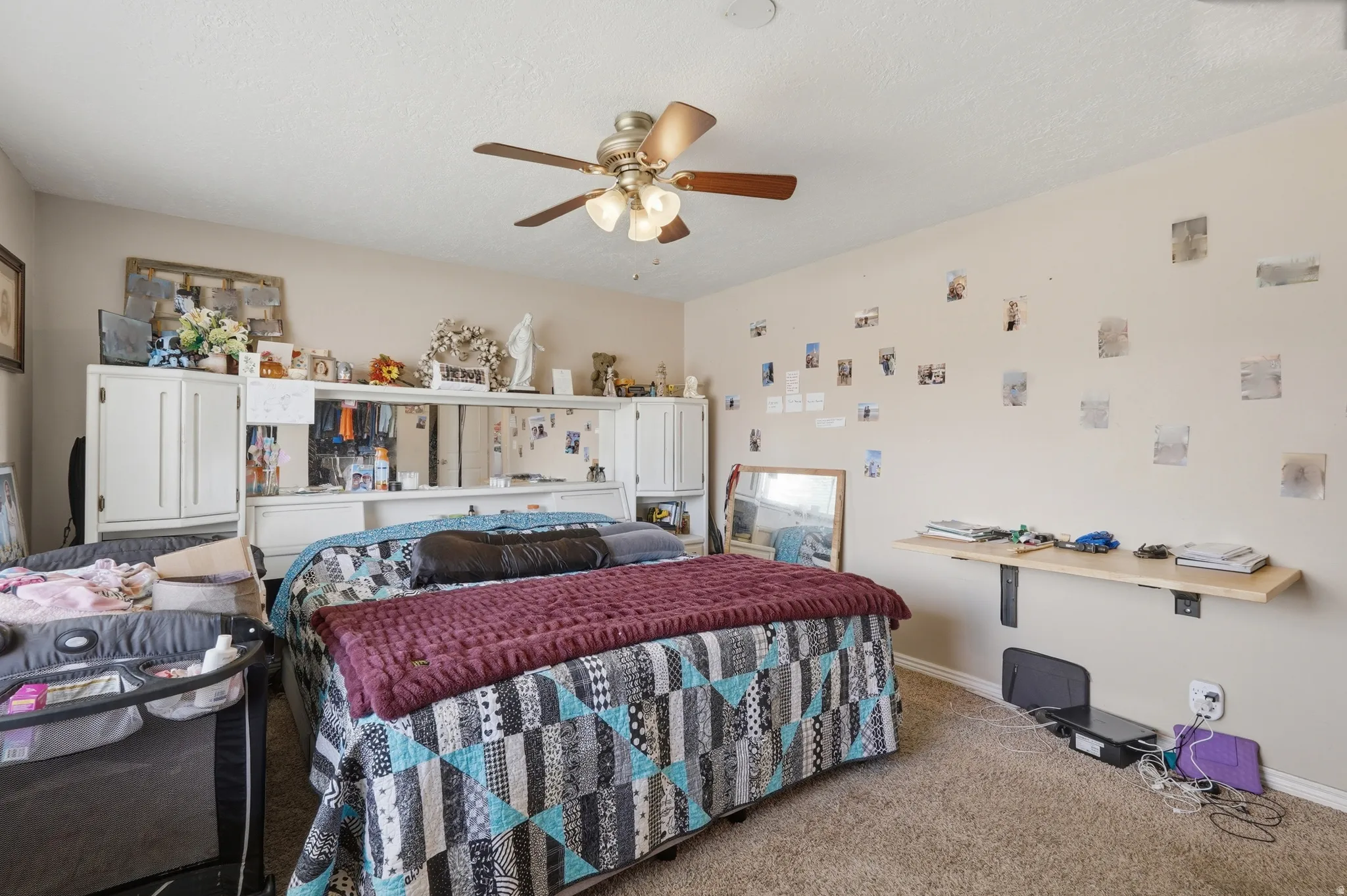 Carpeted bedroom featuring a ceiling fan with integrated lighting