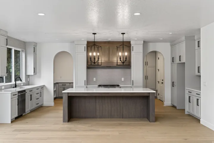 Open-concept kitchen featuring an oversized island with a white countertop