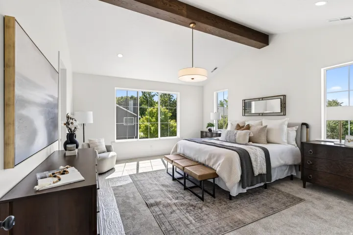 Vaulted ceiling with an exposed wood beam, large picture windows, recessed lighting, and soft carpet flooring