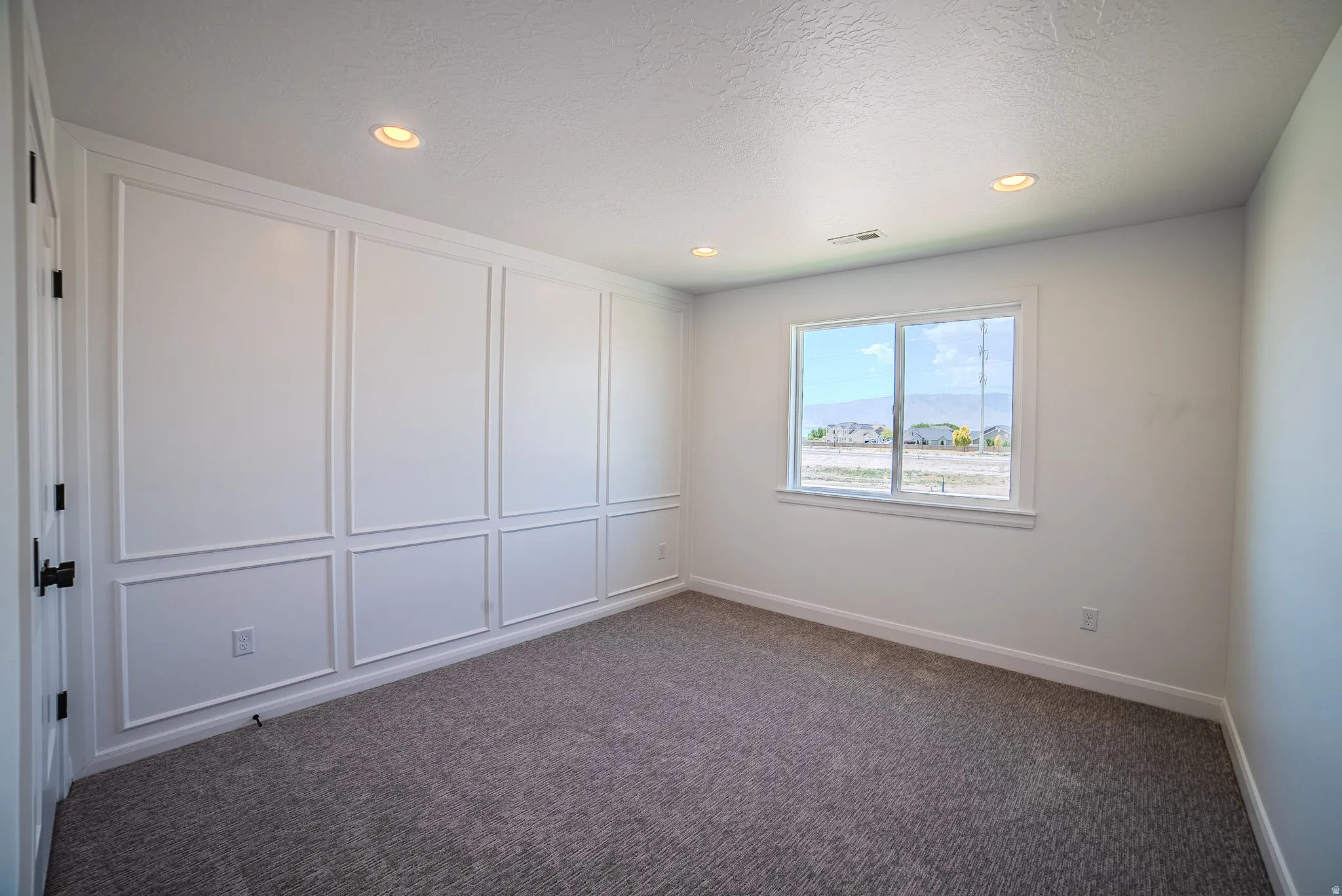 Accent wall with decorative paneling and white trim