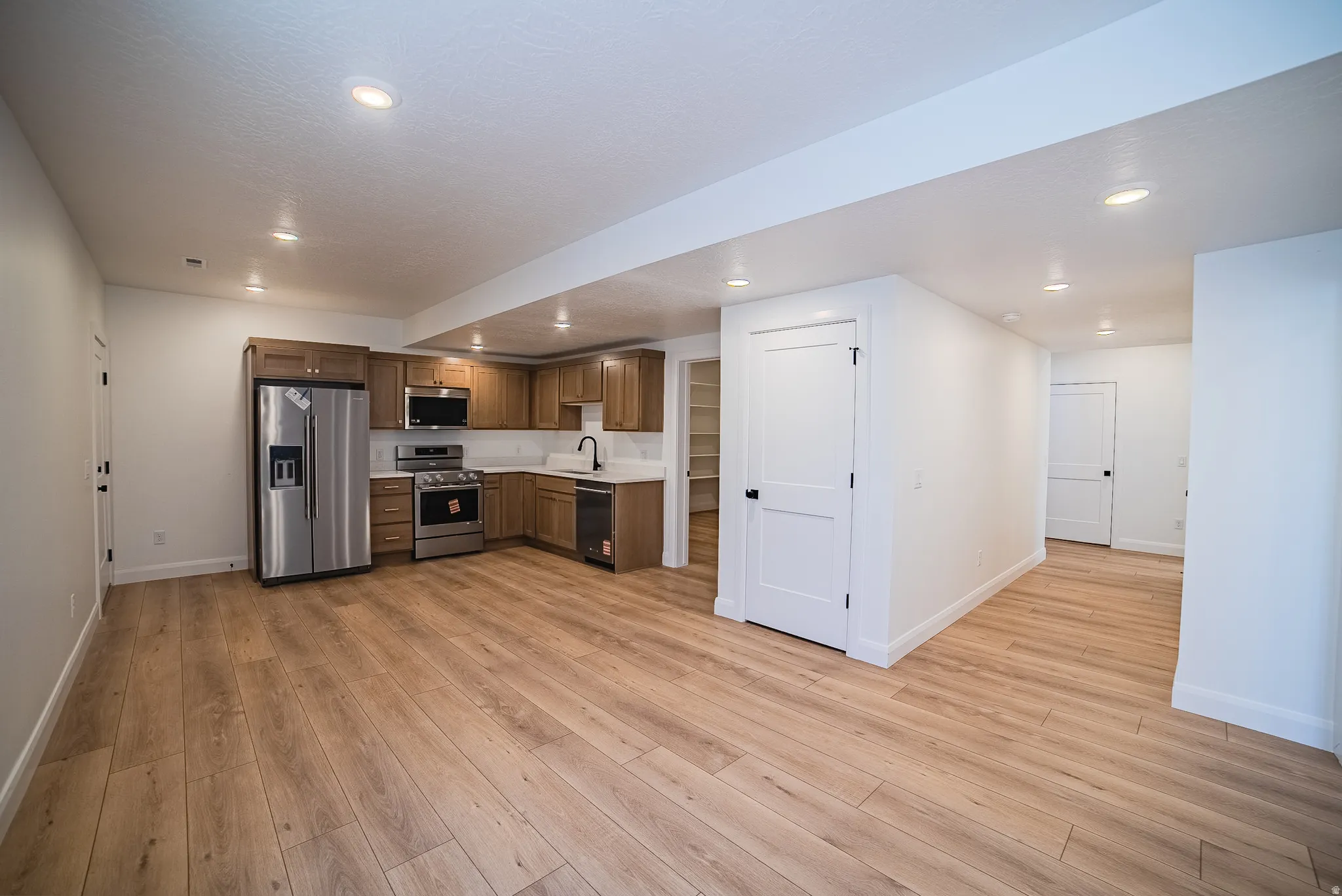 Open-concept living space with wood-finish flooring throughout