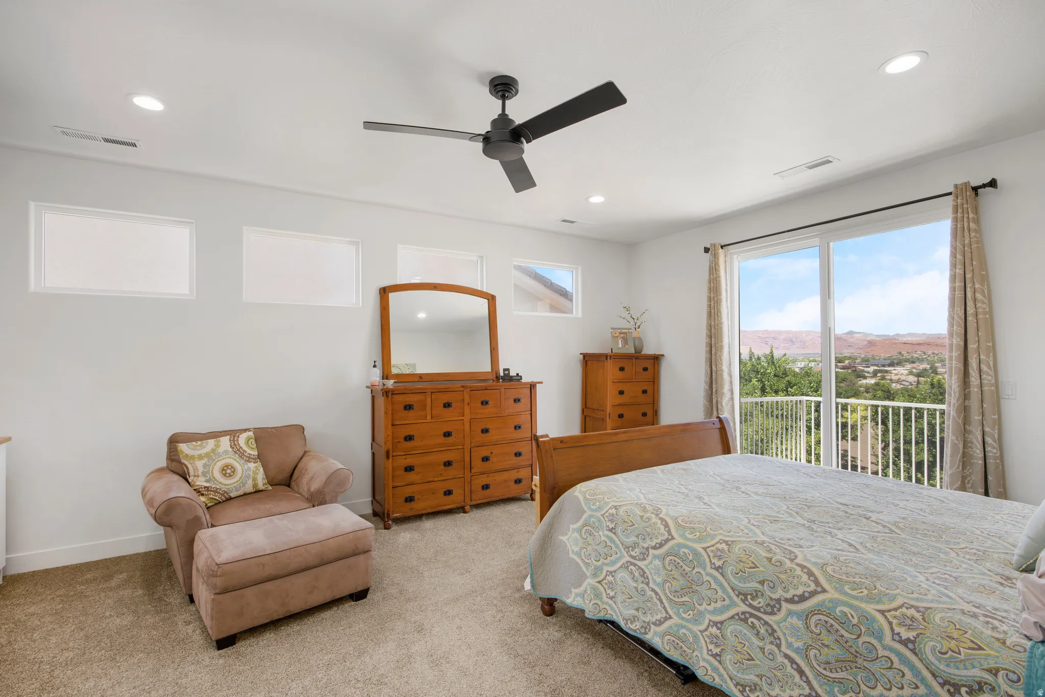 Spacious room featuring light-colored carpeting and white walls