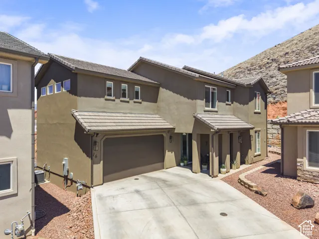 Two-story stucco residence with a two-car garage and a covered entry