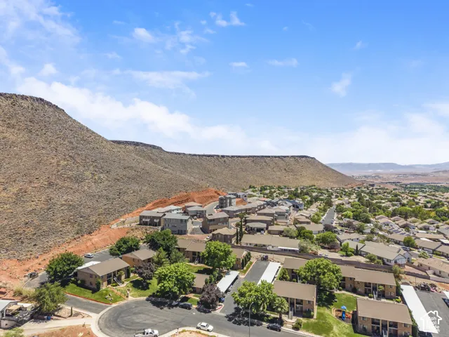 Aerial perspective showcasing a residential community nestled at the base of a prominent mountain