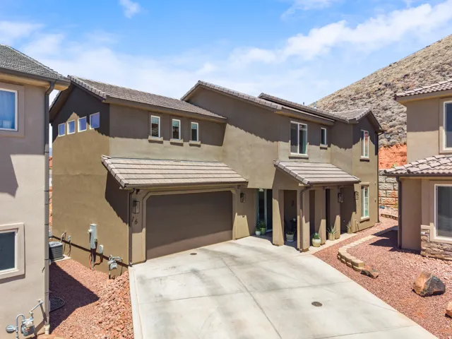 Two-story stucco residence with a two-car garage and a covered entry