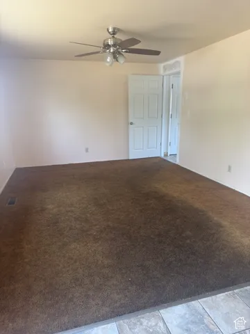Spacious room with plush brown carpeting and light-toned walls