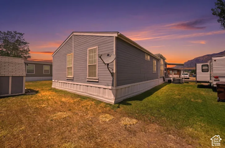 Light gray siding exterior with white trim and white skirting