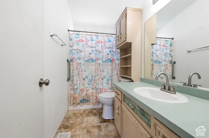 Vanity with an integrated sink and mirror, providing counter space and storage