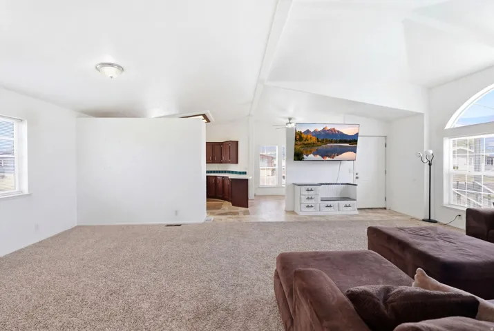 Open-concept living area with vaulted ceilings and abundant natural light