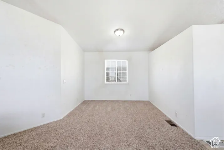 Neutral wall finishes and light brown carpeting