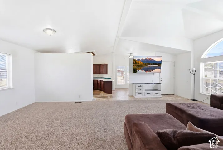 Open-concept living area with vaulted ceilings and abundant natural light