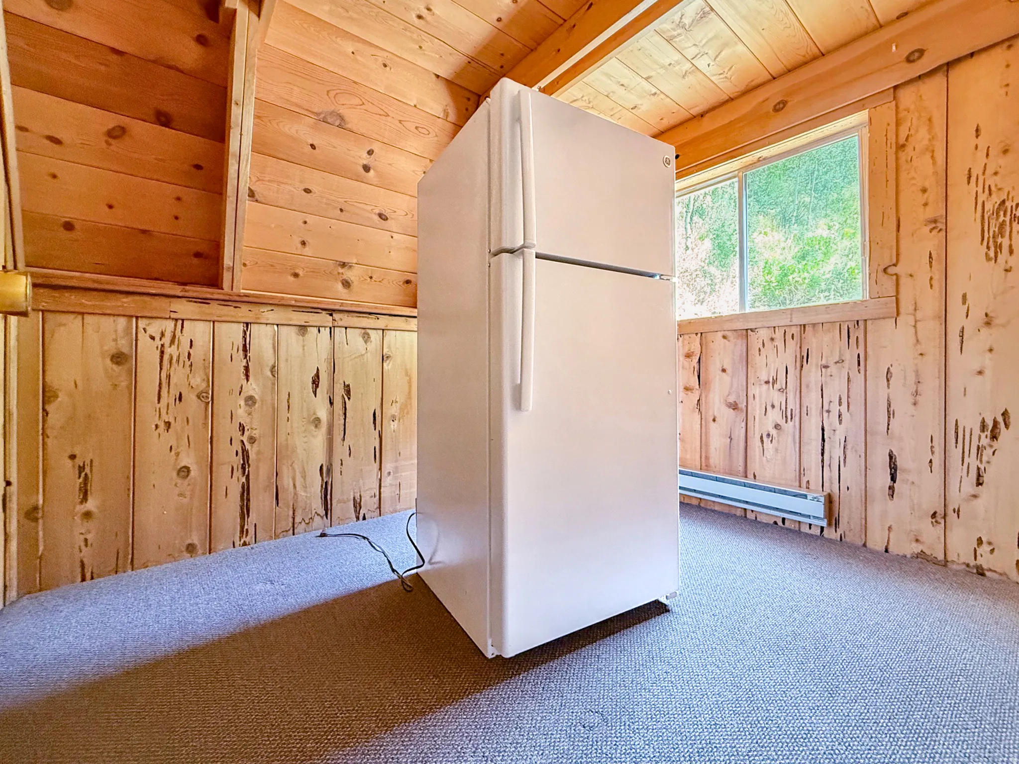 Room featuring wood plank ceiling, wood paneled walls, and carpet flooring