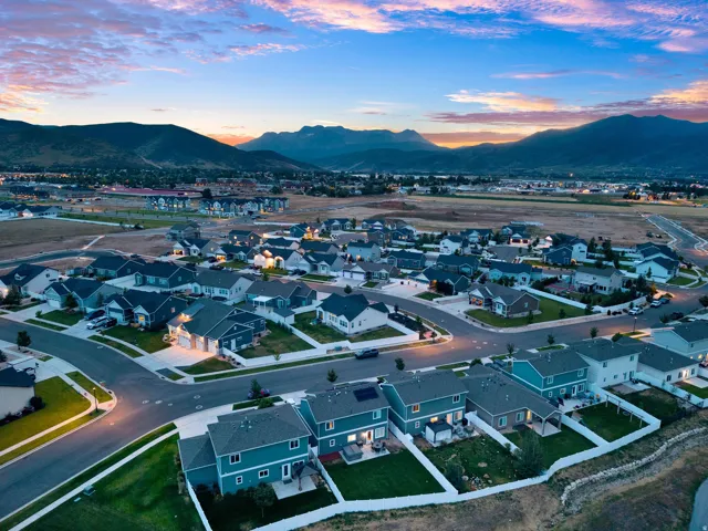Residential community featuring a variety of single-family homes, paved streets, and green spaces