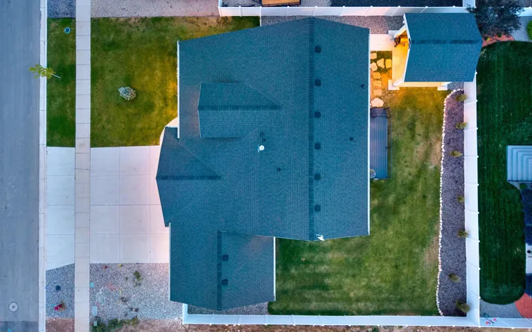 Spacious asphalt shingle roofline over a residential property