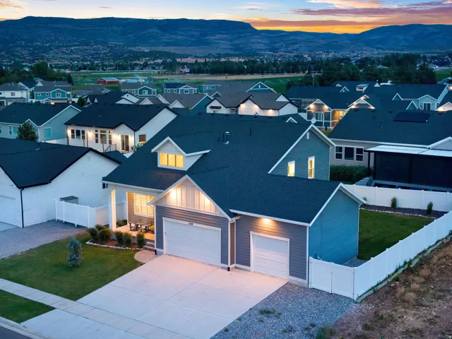 Contemporary single-story residence with a dark roof and light blue siding