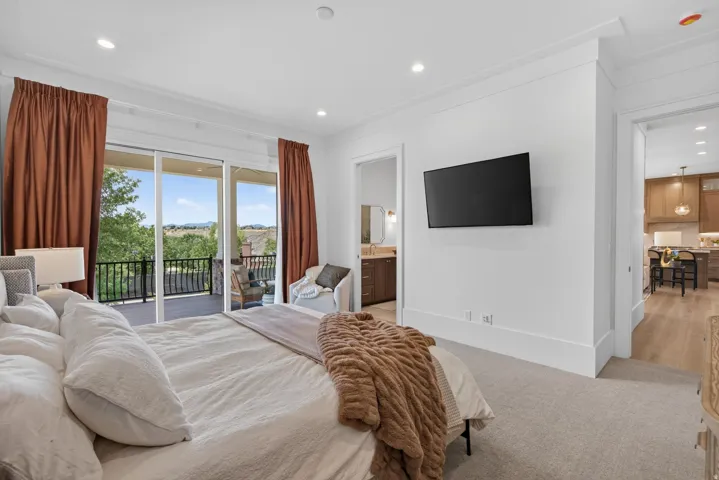 Guest House Expansive room with neutral carpeting and a wall-mounted television