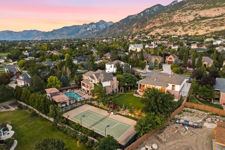 Expansive property featuring a private tennis court, swimming pool, and dedicated pool house