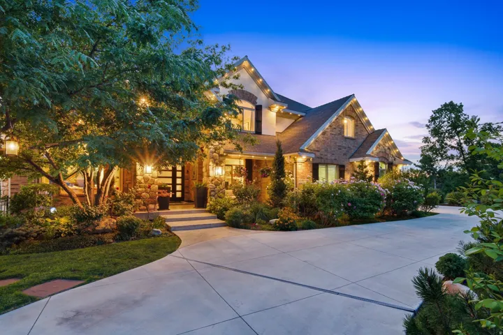 Stately residence featuring a brick and stone facade, multi-gabled roofline, and a prominent front entry