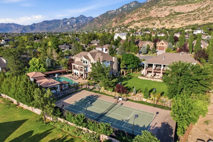 Expansive estate with 2 separate homes featuring a private tennis court, infinity swimming pool, and landscaped grounds