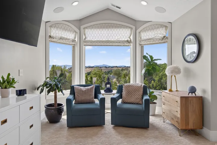 Bay window seating area with arched transoms and distant landscape