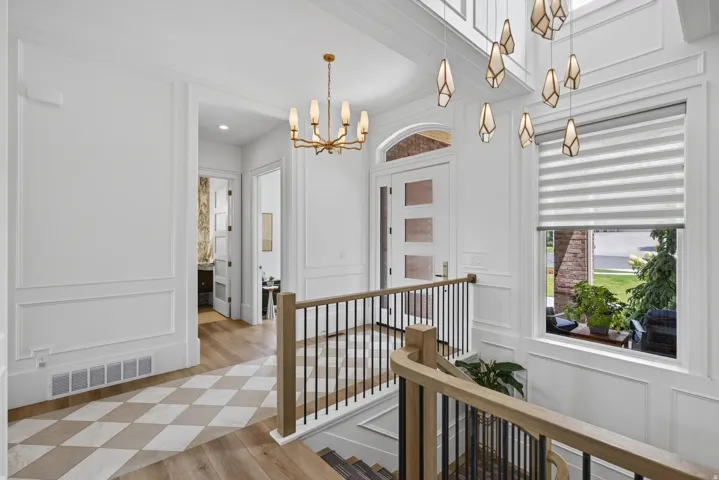 Guest House Entry foyer featuring a multi-level staircase with wood railing and black iron balusters