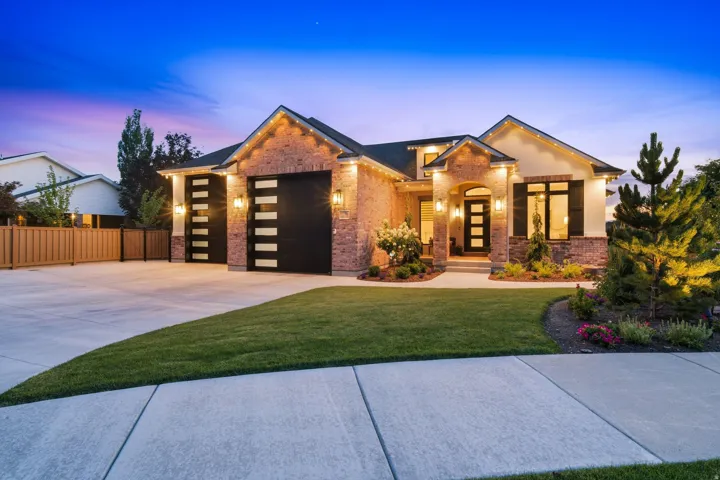 Contemporary residence featuring a brick and stucco facade with dark trim accents