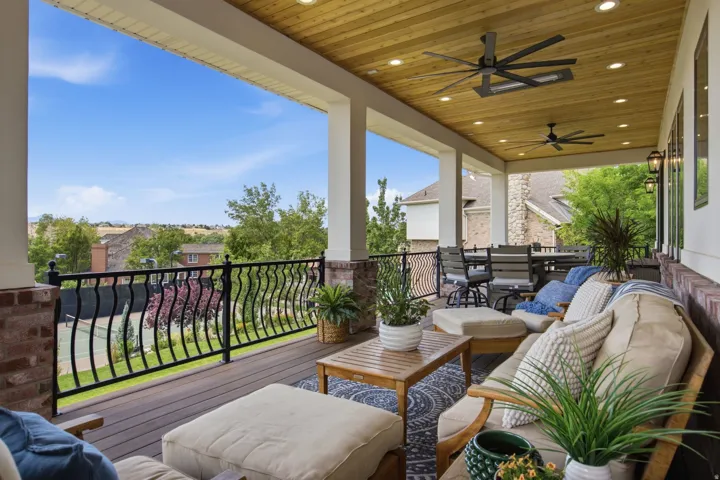 Guest House Expansive covered patio featuring a wood-finish plank ceiling with recessed lighting and ceiling fans