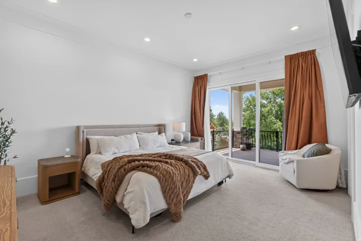 Guest House Bedroom featuring broadloom carpeting, a built-in recessed lighting array, and a crown molding accent