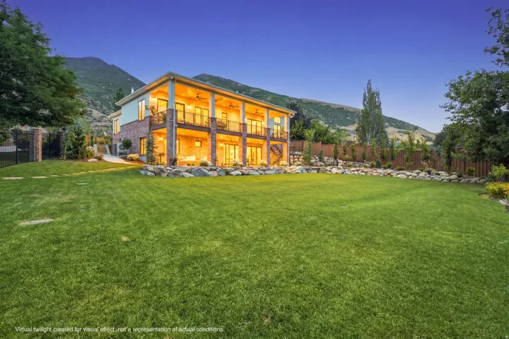 Guest House Expansive manicured lawn with a two-story residence featuring brick and siding facades
