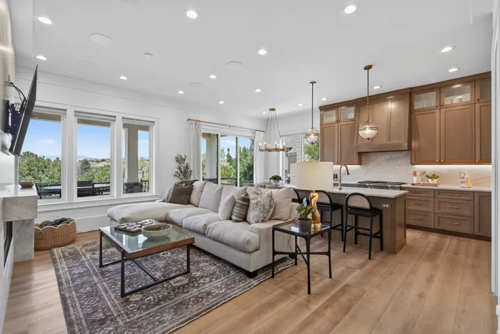 Guest House Open-concept living space featuring wood-finish flooring, recessed lighting, and a white marble fireplace surround