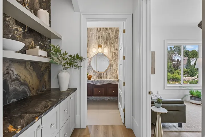 Guest House Custom cabinetry with crystal hardware and a dark stone countertop