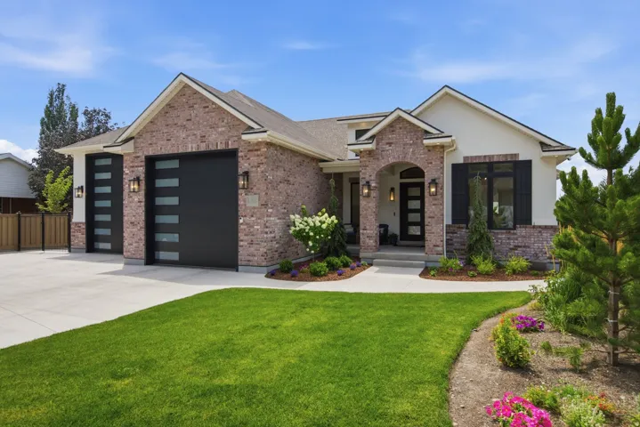 Guest House Brick and stucco exterior with multiple gables and a covered entry