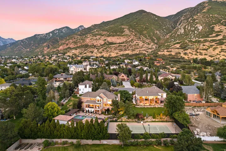 Expansive property featuring a tennis court, swimming pool, and multiple patios