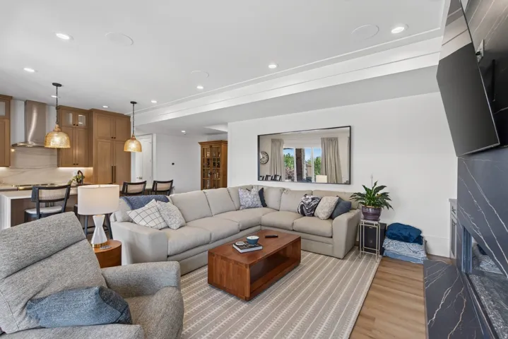 Guest House Open-concept living space featuring wood-finish flooring, recessed lighting, and crown molding