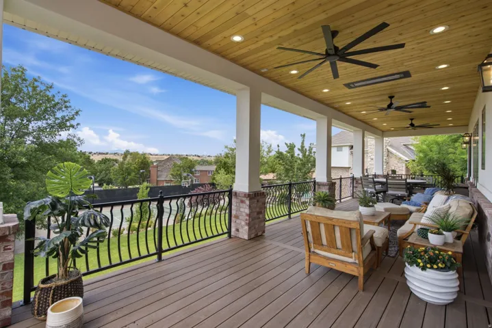 Guest House Expansive covered outdoor living space featuring a wood-finish ceiling, recessed lighting, and multiple ceiling fans