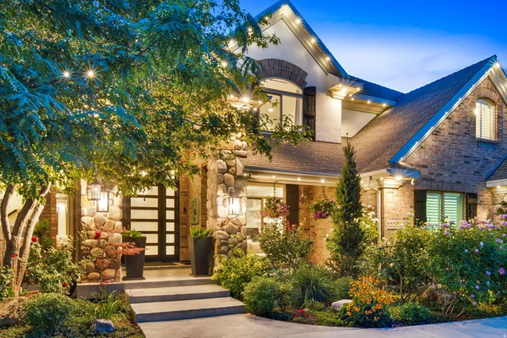 Stunning property exterior featuring a multi-material facade with stone and brick accents