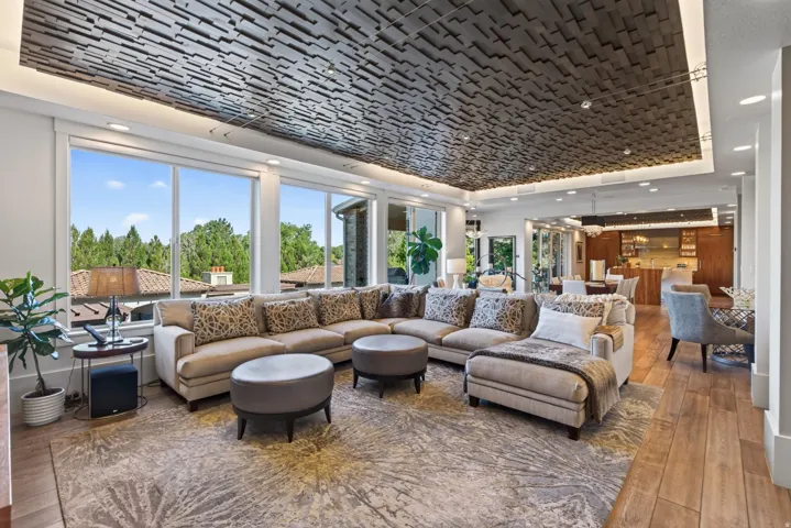 Living area featuring a textured ceiling with recessed lighting, large windows, wood-finish flooring, and an open concept design