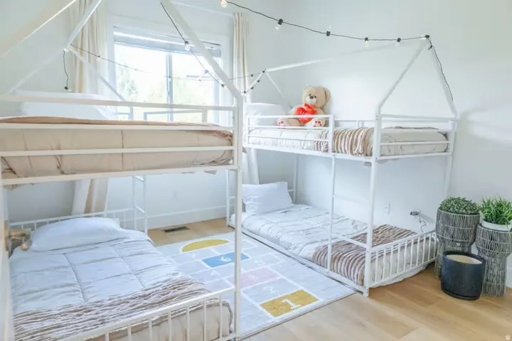 Bright room featuring light wood-finish flooring and white walls