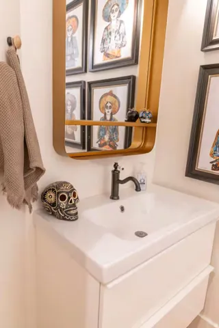 White wall-mounted vanity with integrated rectangular sink and dark-finish faucet